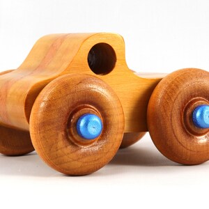 Wood Toy Monster Truck Handmade Form Hardwood and Finished With Amber Shellac With Metallic Saphire Blue Trim.