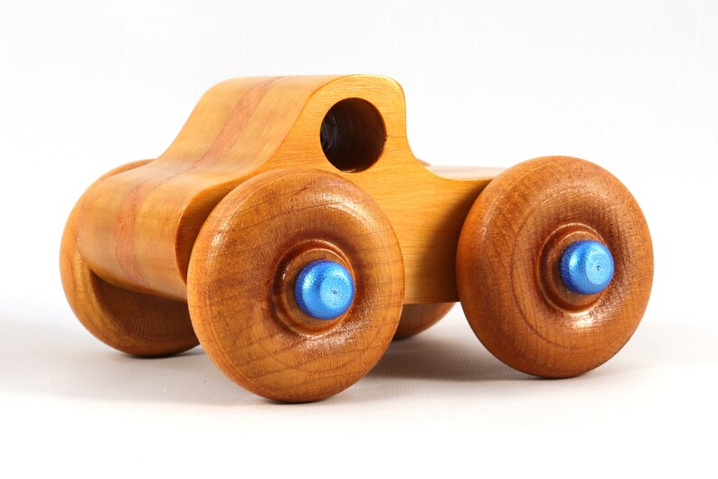 Wood Toy Monster Truck Handmade Form Hardwood and Finished With Amber Shellac With Metallic Saphire Blue Trim.