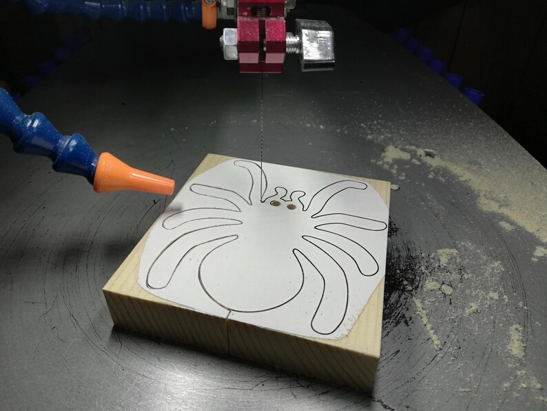 Handmade unfinished wooden Halloween spider cutout from Odin's Toy Factory Snazzy Spooks Collection. Solid wood hand-cut spider, paintable, freestanding design. Approximate size 3.5 inches height by 3.5 inches width by 0.75 inches thick. Made in Tallahassee, Florida, USA.