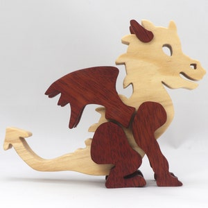 Hand-crafted baby dragon mythical fantasy animal figurine made from contrasting high-quality hardwoods and finished with non-toxic oils and waxes. Perfect for any dragon enthusiast.