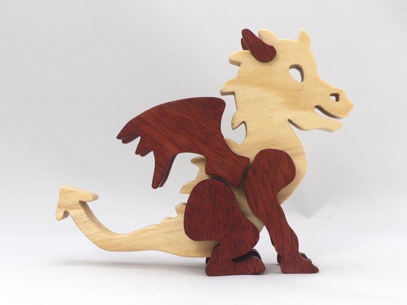 Hand-crafted baby dragon mythical fantasy animal figurine made from contrasting high-quality hardwoods and finished with non-toxic oils and waxes. Perfect for any dragon enthusiast.