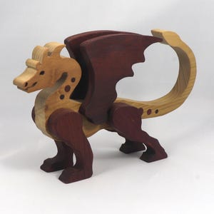 Handmade wood dragon figurine made from select grade contrasting hardwoods and hand-finished with a custom mixture of mineral oil and waxes.