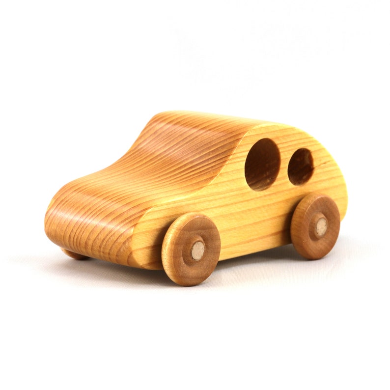 A handmade wooden toy car from the My Play Pal collection finished with durable satin polyurethane and amber shellac. It is made to order.