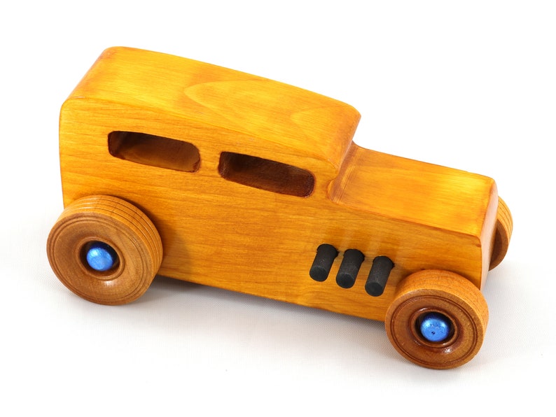 Handcrafted wooden hot rod toy car modeled after a classic '32 sedan. Finished with amber shellac and adorned with metallic sapphire blue and black trim. This unique piece is part of my Hot Rod Collection.