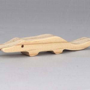 Handmade toy alligator cutout from the Itty Bitty Animal Collection. Crafted with traditional woodworking tools, this unfinished wood alligator is freestanding, smooth-sanded, and ready to paint. Perfect for stacking and imaginative play.