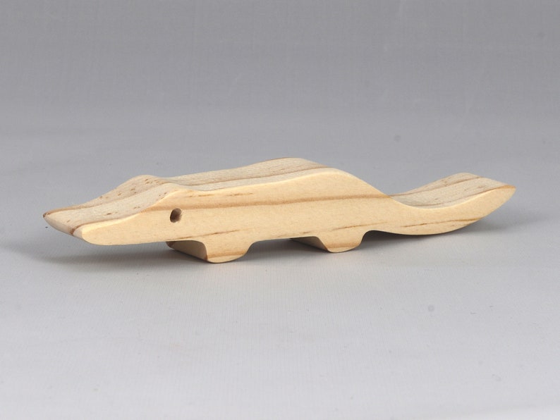 Handmade toy alligator cutout from the Itty Bitty Animal Collection. Crafted with traditional woodworking tools, this unfinished wood alligator is freestanding, smooth-sanded, and ready to paint. Perfect for stacking and imaginative play.