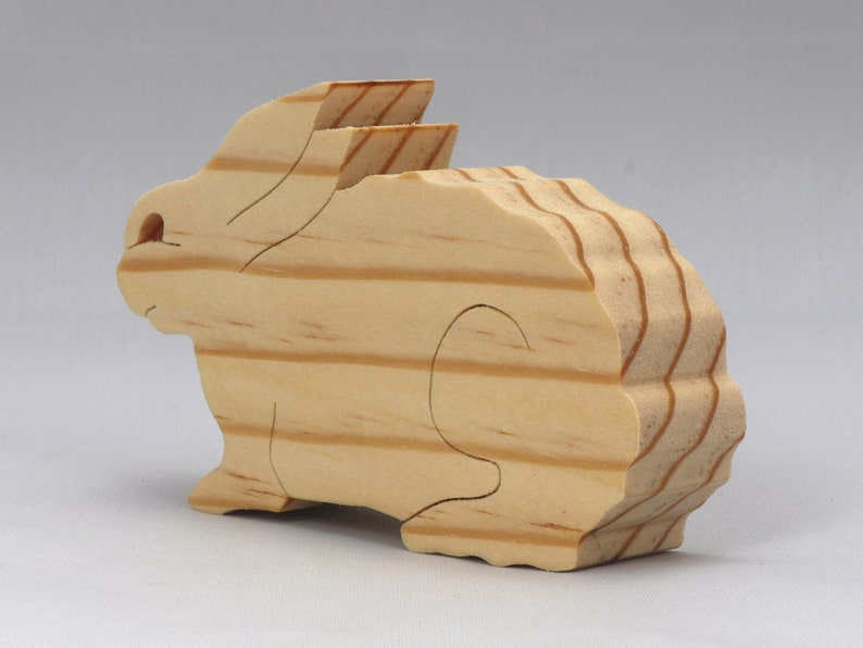 This is an unfinished wooden Rabbit cutout from solid wood using traditional woodworking techniques. Sanded smooth and ready to paint, stain, or customize. Freestanding design for small hands, toddlers, young children, crafters, collectors, and display. I take custom orders for any animal, quantity, and mix — including large ornament orders. Mix and match, request a different size, or send a drawing or pattern. Handmade by Odin's Toy Factory in Tallahassee, Florida, USA.
