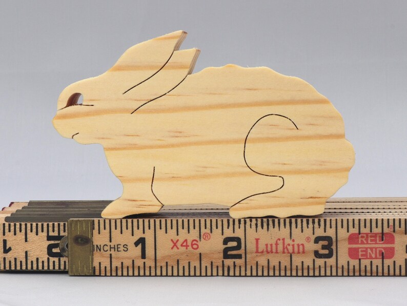 This is an unfinished wooden Rabbit cutout from solid wood using traditional woodworking techniques. Sanded smooth and ready to paint, stain, or customize. Freestanding design for small hands, toddlers, young children, crafters, collectors, and display. I take custom orders for any animal, quantity, and mix — including large ornament orders. Mix and match, request a different size, or send a drawing or pattern. Handmade by Odin's Toy Factory in Tallahassee, Florida, USA.