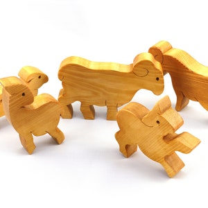 Handmade wooden toy stacking puzzle with five freestanding goats finished with a custom blend of nontoxic oils and waxes.