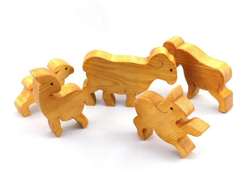 Handmade wooden toy stacking puzzle with five freestanding goats finished with a custom blend of nontoxic oils and waxes.