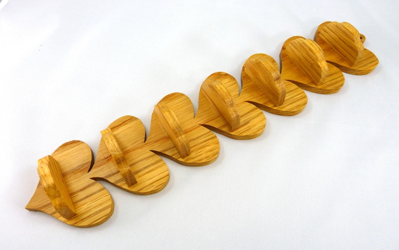 Handmade heart-shaped shelf crafted from reclaimed oak hardwood and finished with polyurethane. Perfect for displaying small items and adding rustic charm to home decor.