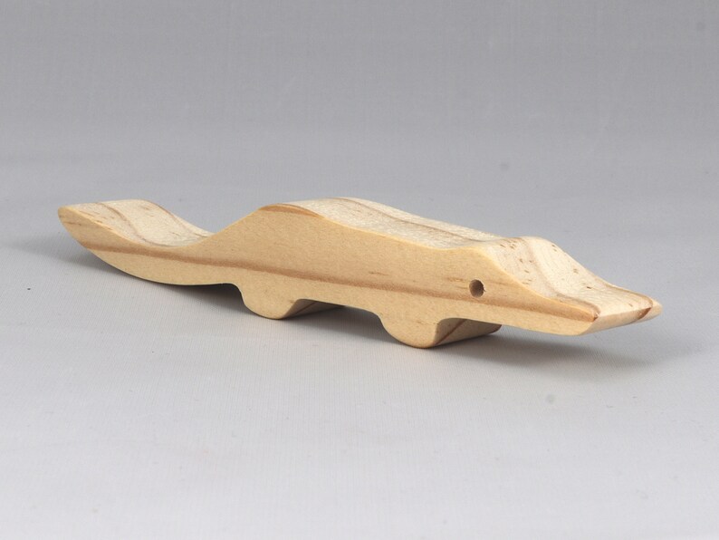 Handmade toy alligator cutout from the Itty Bitty Animal Collection. Crafted with traditional woodworking tools, this unfinished wood alligator is freestanding, smooth-sanded, and ready to paint. Perfect for stacking and imaginative play.