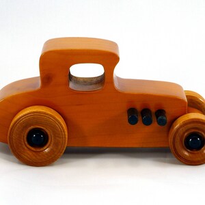 Handmade Wood Toy Car Hot Rod Based On The 1927 T-Coupe. It Has Been Hand-Finished With Multiple Coats Of Amber Shellac And Trimmed With Black Acrylic Paint.
