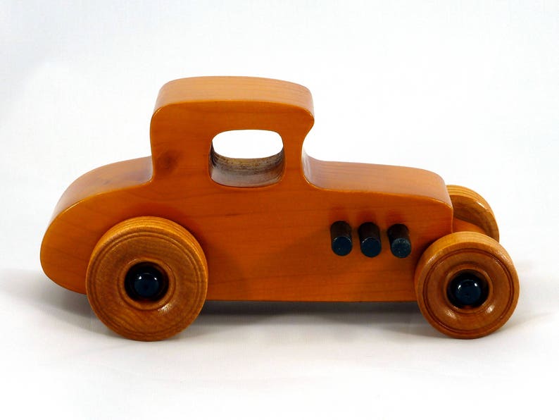 Handmade Wood Toy Car Hot Rod Based On The 1927 T-Coupe. It Has Been Hand-Finished With Multiple Coats Of Amber Shellac And Trimmed With Black Acrylic Paint.