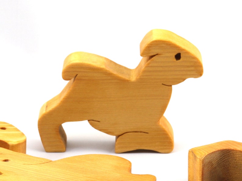 Handmade wooden toy stacking puzzle with five freestanding goats finished with a custom blend of nontoxic oils and waxes.