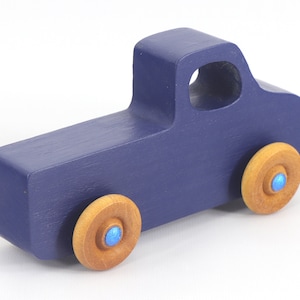 Handmade wooden toy pickup truck handmade and painted navy blue with amber shellac wheels and metallic sapphire blue trim. It's a little blue truck from my Play Pal Collection.