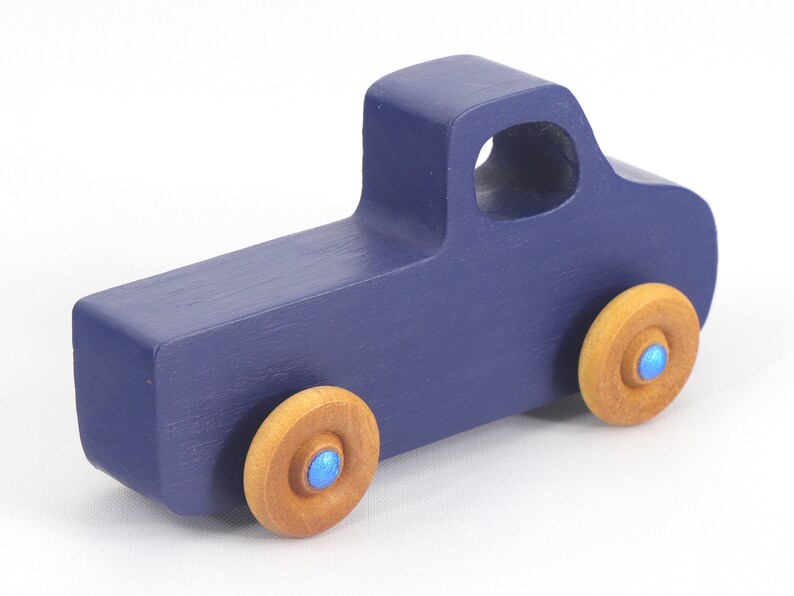 Handmade wooden toy pickup truck handmade and painted navy blue with amber shellac wheels and metallic sapphire blue trim. It's a little blue truck from my Play Pal Collection.