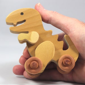 Handmade wooden push toy Tyrannosaurus Rex dinosaur made from select grade hardwoods and finished with a non-toxic coating.