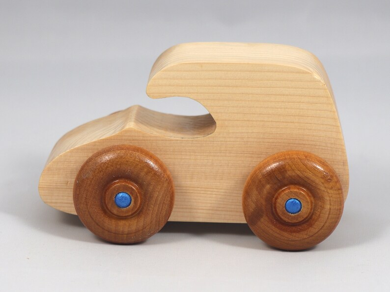 Handmade wooden toy car. The body is finished with clear shellac, and the wheels are finished with amber shellac. The hubs are painted with metallic sapphire blue trim.
