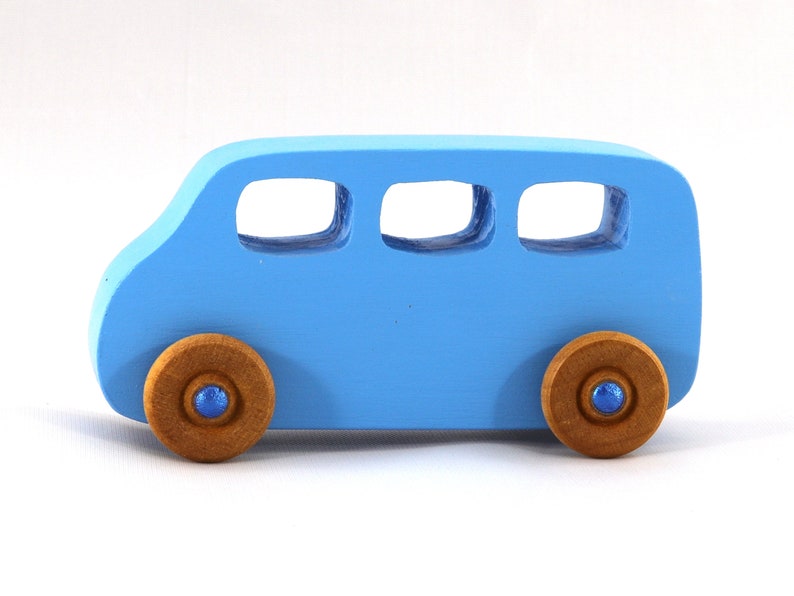 A Handmade wood toy mini van hand-painted baby blue with metallic sapphire blue trim and wheels finished with nonmarring amber shellac from my Play Pall Collection.