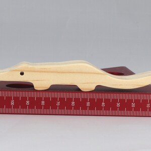 Handmade toy alligator cutout from the Itty Bitty Animal Collection. Crafted with traditional woodworking tools, this unfinished wood alligator is freestanding, smooth-sanded, and ready to paint. Perfect for stacking and imaginative play.