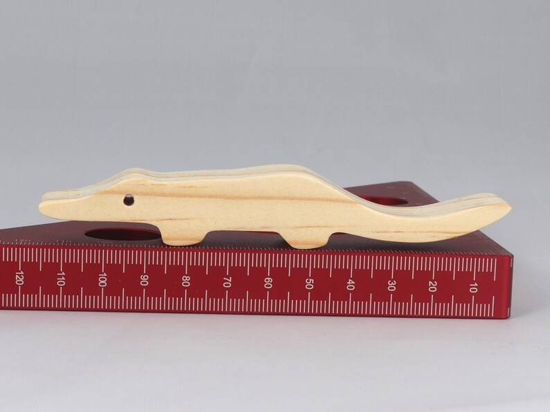 Handmade toy alligator cutout from the Itty Bitty Animal Collection. Crafted with traditional woodworking tools, this unfinished wood alligator is freestanding, smooth-sanded, and ready to paint. Perfect for stacking and imaginative play.
