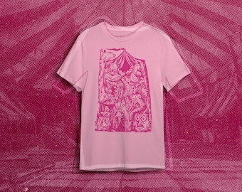 May include: Pink t-shirt with a graphic print of a group of cartoon characters in a tent. The characters are pink and white and the tent is pink.