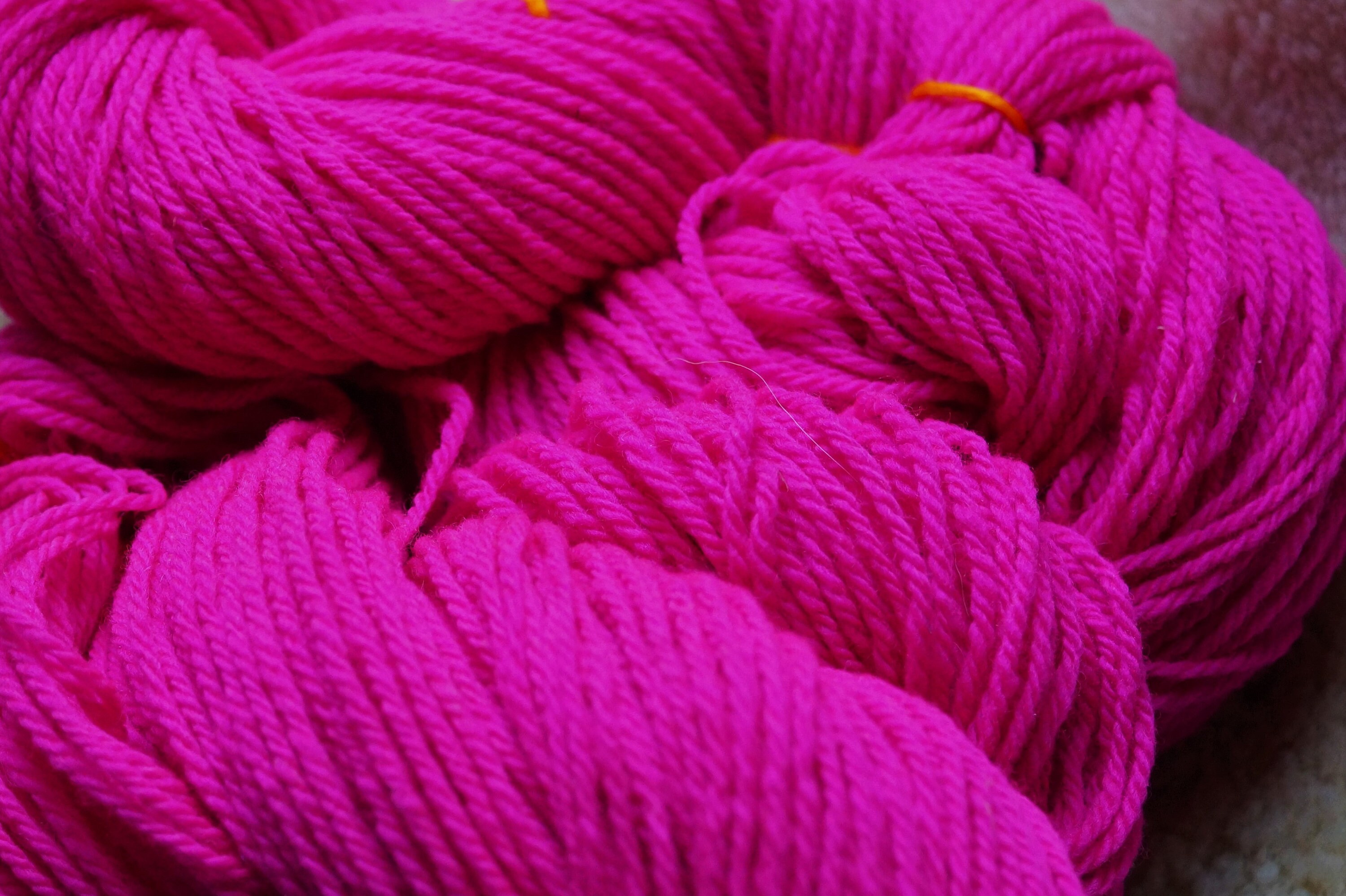 Neon Pink worsted wool hand dyed 3 ply soft wool yarn from our