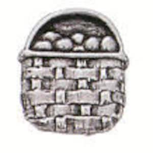 May include: A silver-toned pewter basket filled with small round objects, possibly fruit or vegetables. The basket has a woven design and a handle.