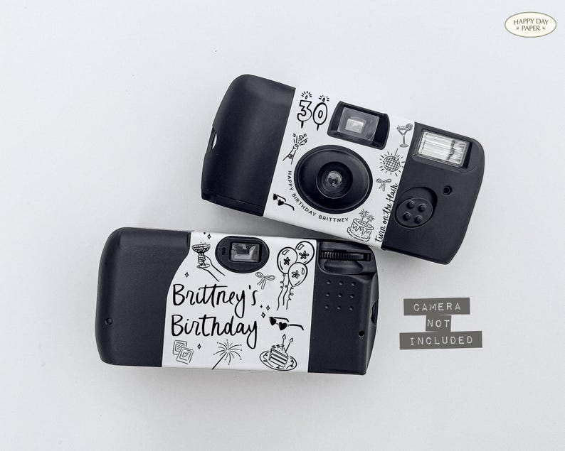 May include: Two black disposable cameras with white labels featuring birthday-themed illustrations and text. One camera says "30" and "Happy Birthday Brittney". The other says "Brittney's Birthday". The text "Camera Not Included" is also present.