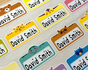May include: A sheet of colorful name tag stickers with animal designs, including a bear, duck, tiger, cat, dinosaur, owl, and rhino. Each tag has the name "David Smith" printed in black.