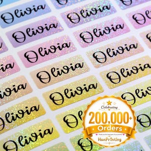May include: A sheet of rectangular adhesive labels featuring a holographic finish with a gradient of pastel colors. Each label is printed with the name Olivia in a black cursive script. A gold circular badge displays Celebrating 200,000+ Orders.