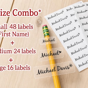 May include: A set of clear adhesive labels with black text reading Michael or Michael Davis, featuring small heart or flower icons. The labels are presented in small, medium, and large sizes alongside a yellow pencil, with text indicating a size combo.