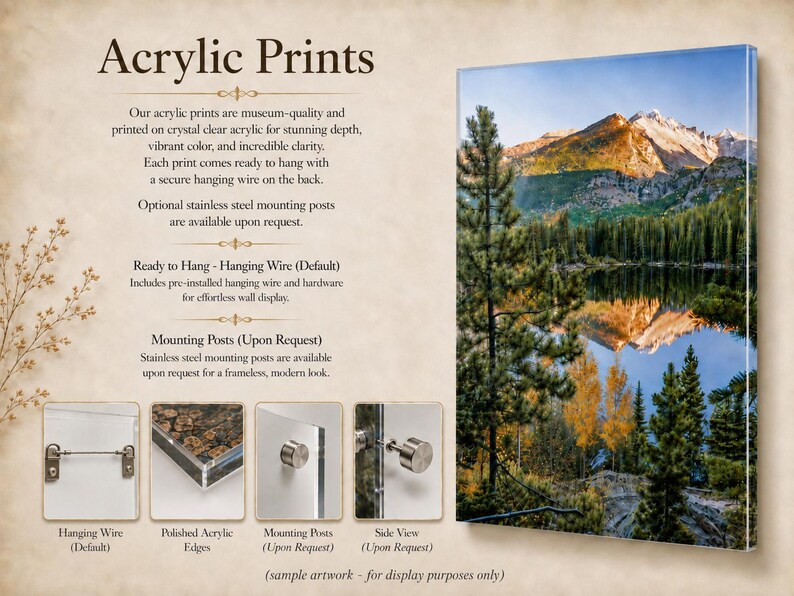 May include: An acrylic print featuring a mountain landscape reflected in a lake, surrounded by pine trees. The image includes text detailing product features, a hanging wire, polished acrylic edges, and optional stainless steel mounting posts.
