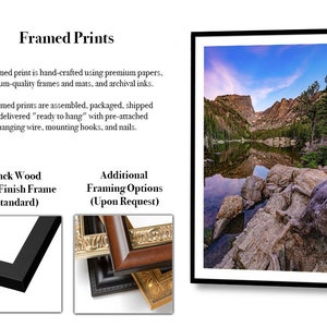 May include: A framed print featuring a landscape photograph of a mountain lake with rocky shores and a blue sky. The print is encased in a black wood satin finish frame. Text on the image includes Framed Prints, Black Wood Satin Finish Frame.