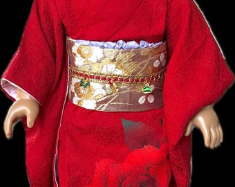 A formal kimono of deep crimson, crafted from thick silk and worn in Japan.