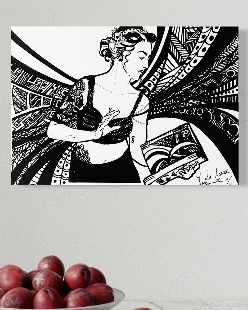 May include: Black and white artwork depicting a woman in a bra and skirt, holding a book. The artwork features intricate patterns and designs, with a crown on the woman's head. The image is signed and numbered.