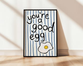 May include: A white and blue striped poster with black text that reads "you're a good egg" and a black outline of a fried egg with a yellow yolk.