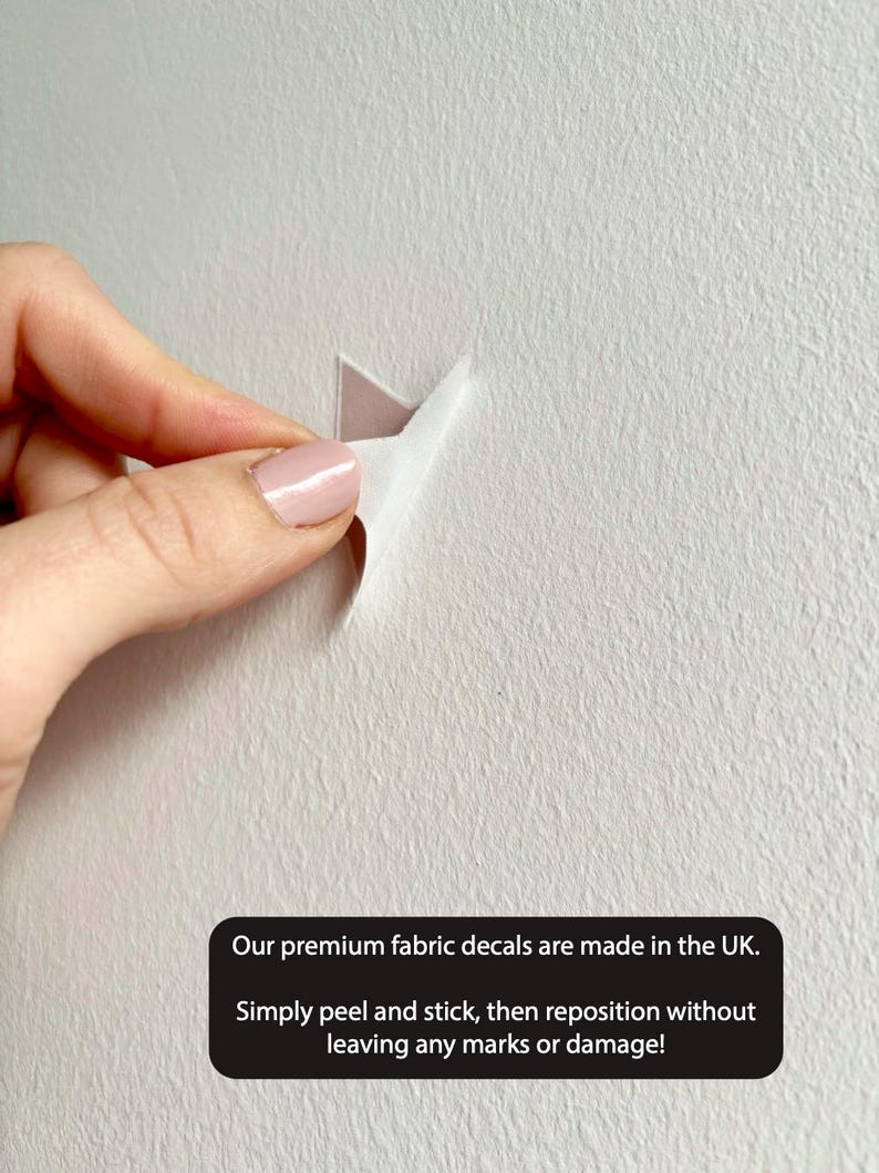 May include: A close-up of a white wall with a fabric decal being peeled away. The text on the image reads: "Our premium fabric decals are made in the UK. Simply peel and stick, then reposition without leaving any marks or damage!"