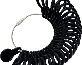 May include: Black plastic ring sizer with a metal chain and a clasp. The sizer has 20 rings of different sizes.