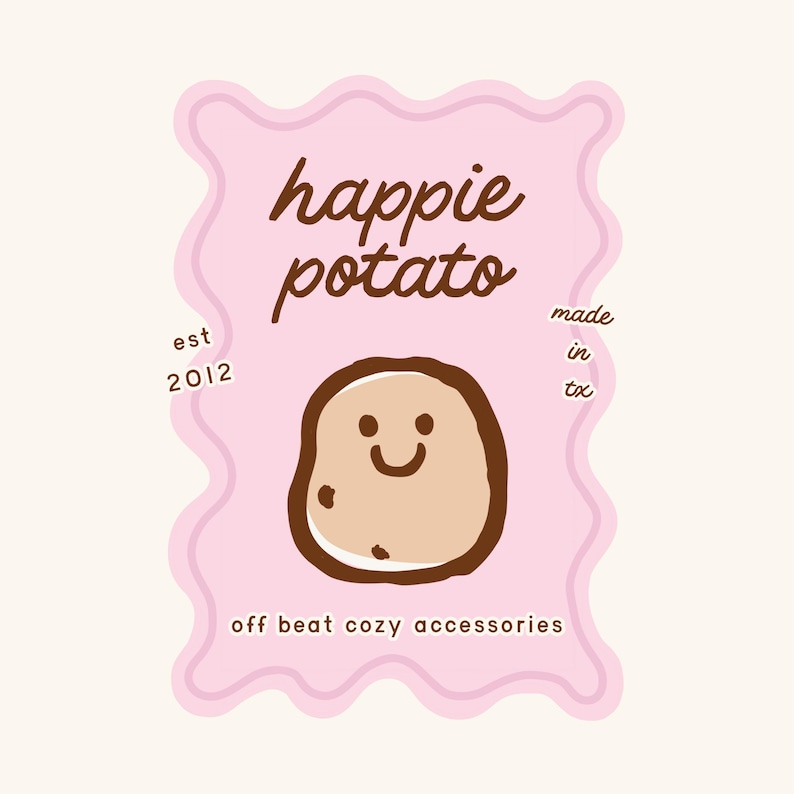 a cheerful potato with a smiley face, surrounded by a pink wavy border and text that reads "happie potato" and "off beat cozy accessories".