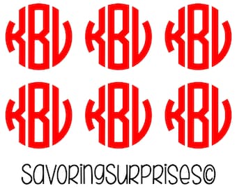 May include: Six red monogram designs with the letters KBL in a circular format. The text "SAVORINGSURPRISES©" is printed in black script below the monograms. The design is on a white background.
