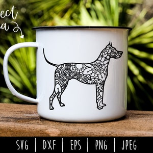 May include: A white ceramic mug with a black handle features a black and white line art illustration of a dog with a floral pattern. The mug is sitting on a wooden surface. The text "SVG | DXF | EPS | PNG | JPEG" is printed below the mug.