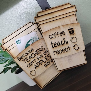 May include: Wooden coffee cup holder with the text "Because teachers can't live on apples alone" and "coffee teach repeat" with a coffee cup and apple graphic.