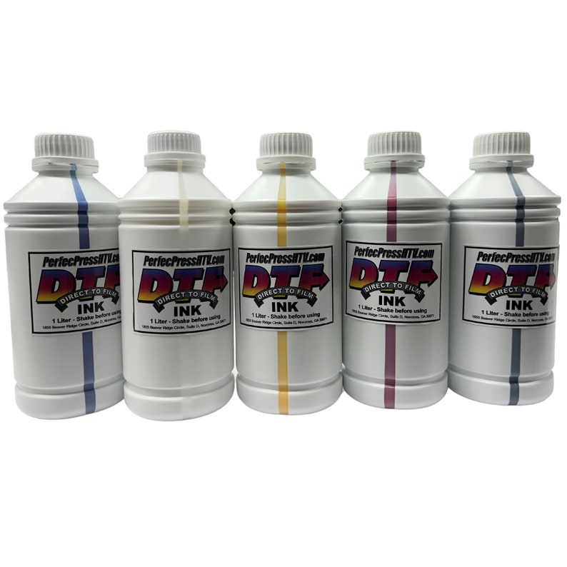 May include: Five 1-litre bottles of direct-to-film ink. The bottles are white with a black and red label that says "PerfecPressITL.com DTF DIRECT TO FILM INK 1 Litre - Shake before using". The bottles are labelled with different colours: blue, white, yellow, pink, and grey.