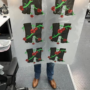 May include: Six black vinyl stickers with a stylized letter H surrounded by green vines and red roses.