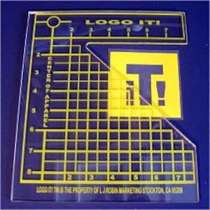 May include: A clear acrylic Logo It! stencil with yellow grid lines and text. The stencil includes the text "LOGO IT!" and "CENTER OF APPAREL". The stencil is marked with numbers from 2 to 8.
