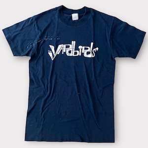 May include: A navy blue t-shirt with a white print of "The  Vapbirds" in a retro font.