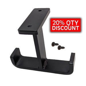 May include: Black metal shelf bracket with two mounting holes and a curved lip. The bracket is designed to support a shelf or other object. Two black screws are included.