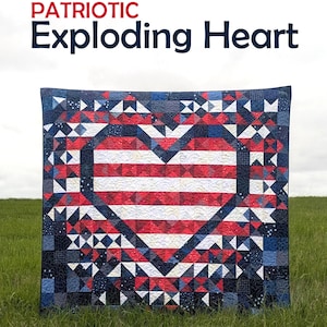May include: A patriotic quilt with a heart design. The heart features red and white stripes, surrounded by a border of blue, red, and white triangles. The quilt is displayed on a grassy field. Text on the quilt reads "PATRIOTIC Exploding Heart".
